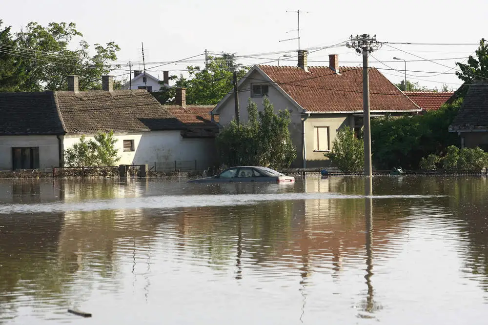 house and street flooded with water
