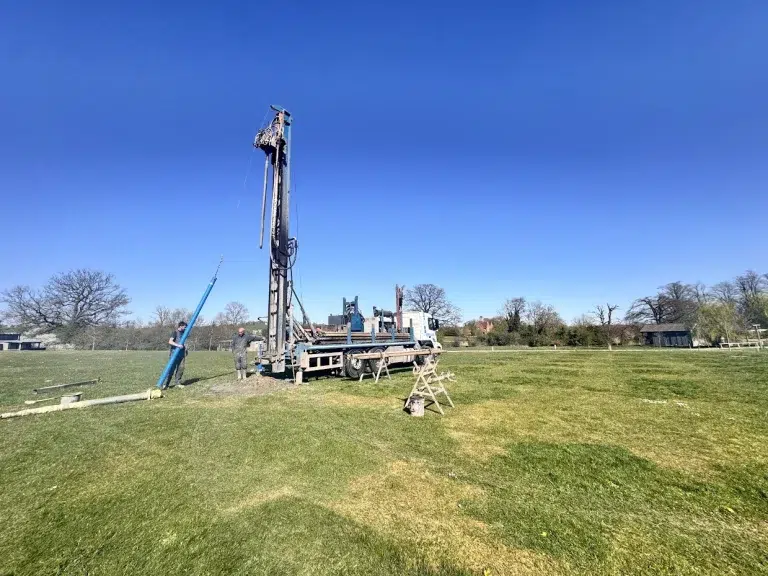Groundwater consultant measuring water levels in a monitoring borehole